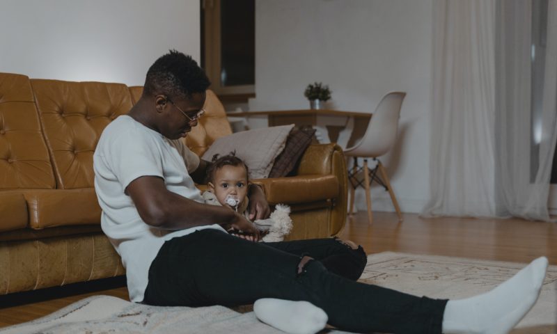 A father looking after a baby at home while on parental leave